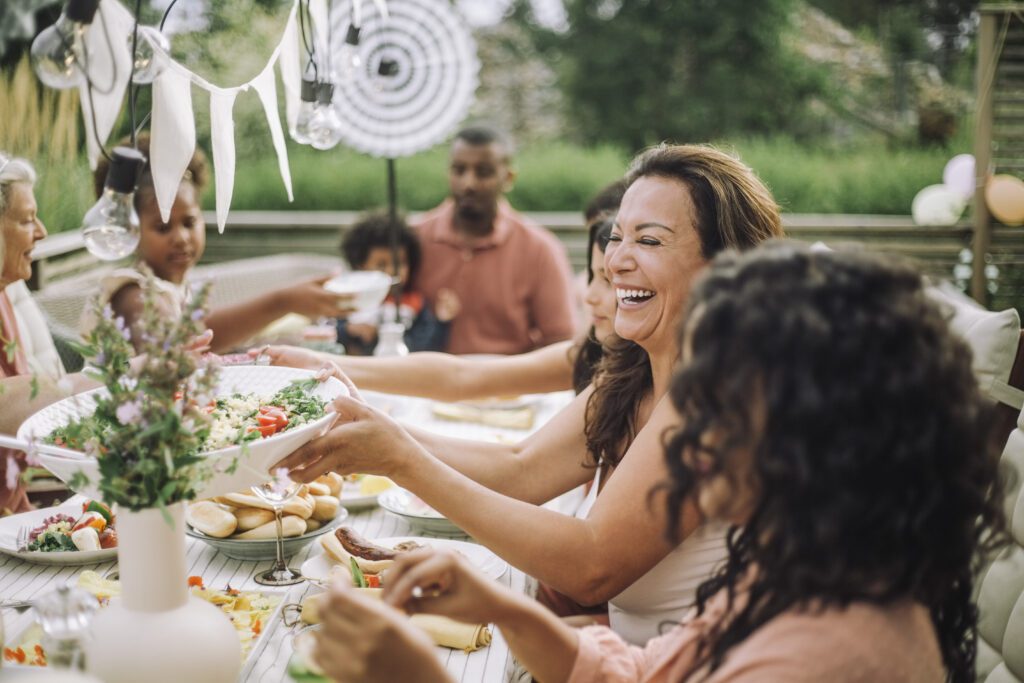 Cheerful family in dinner party at backyard